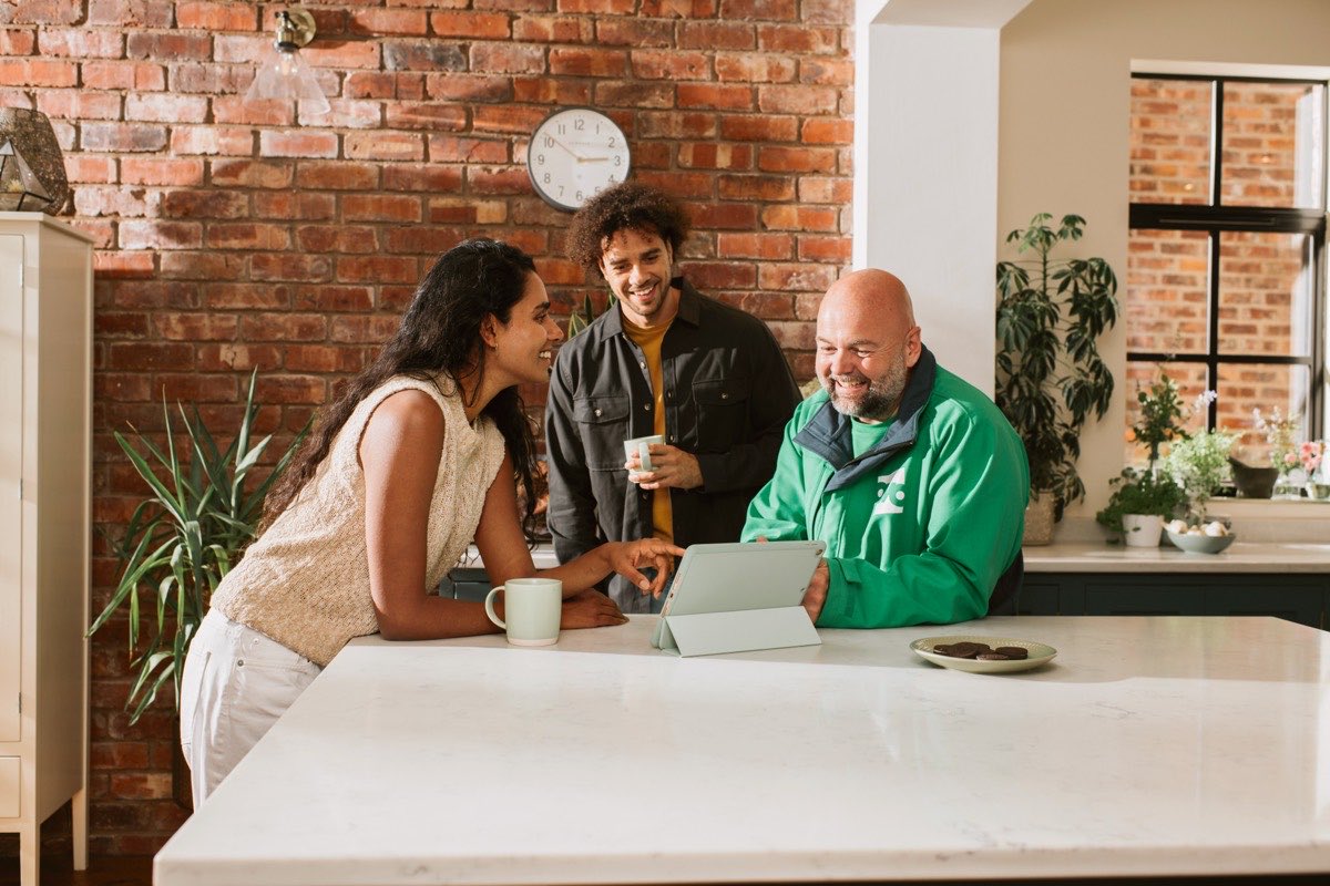 An OVO expert talking a couple through their solar design on a tablet at home
